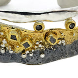 Silberarmband mit weißen und schwarzen Diamanten